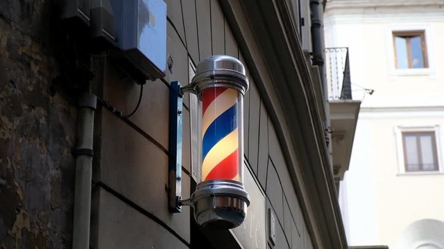 Vintage barbershop and hairdresser symbol. Traditional barber pole rotating in barbershop