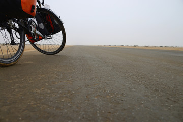 Long distance cycling in the misty Namib, Namibia