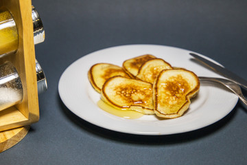  Fried pancakes in a pan with honey