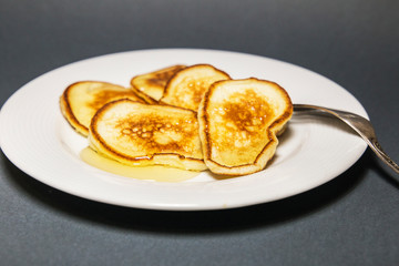  Fried pancakes in a pan with honey