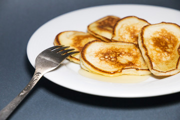  Fried pancakes in a pan with honey