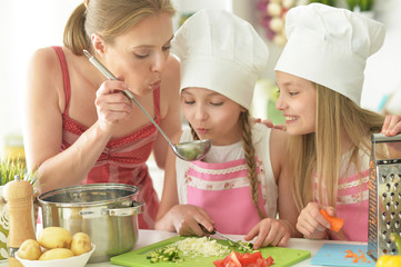 Portrait of cute girls with mother preparing