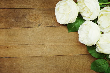 top view space copy with artificial white peony flowers bouquet on wooden background
