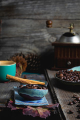 still life,photography coffee table coffee beans in plates and cup, wooden background,coffee grinder, food and drink
