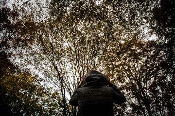 A woman pulls up her hoodie on a cold autumn day.