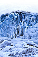Fototapeta na wymiar Snow covered icy waterfall for postcard