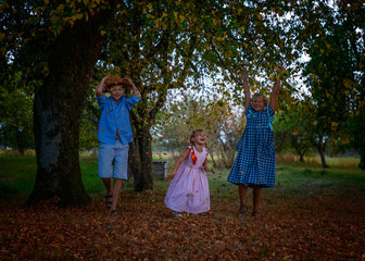 children frolic and shine wind lamps in the fall