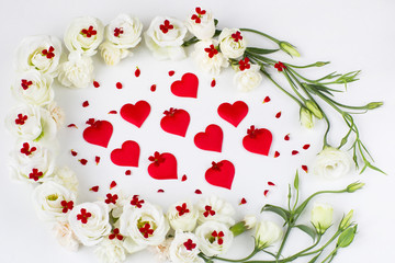 white flowers and red flowers and red satin hearts