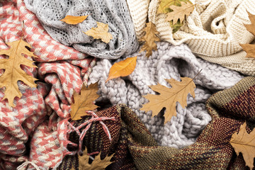 Warm scarves and leaves background