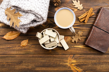 Beautiful coffee and wafers layout on wooden background
