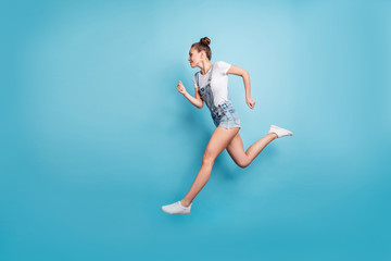 Full length body size photo of quick running girl reaching for some place sportive cute attractive while isolated with blue background