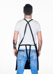 Looking cool while working. Working man or worker back view. Man wearing apron with straps on back. Man standing face away. Caucasian man wearing safety apron