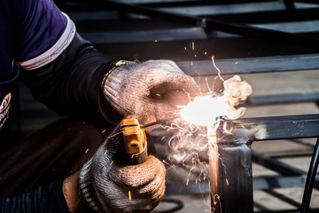 The mechanic is working on welding