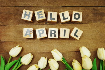 Hello April alphabet letters on wooden background