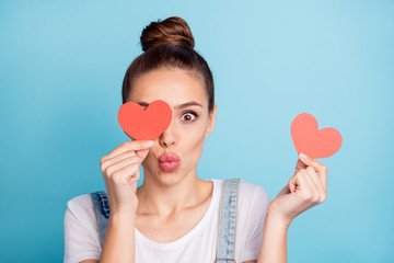 Close up of funky girl hide her eye with red paper card heart send air kisses wear white t-shirt...