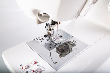 Sewing machine foot. Professional modern sewing machine.