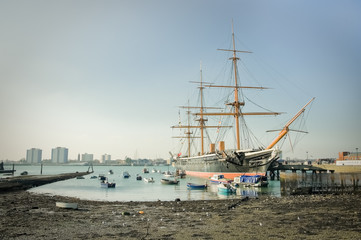 PortsmHMS Warrior, the first iron-clad battleship launched by the British Royal in 1860, now a floating museum moored in Portsmouth Harbour, UK