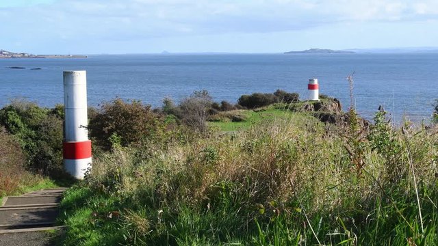 Video of the Firth of Forth estuary and two lighthouses in Aberdour, Fife. Lighthouse near Silversands Bay. Aberdour is a scenic and historic village on the south coast of Scotland.