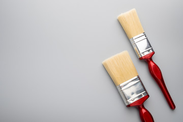 Red handle paint brush on grey background