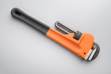 Pipe wrench on grey background