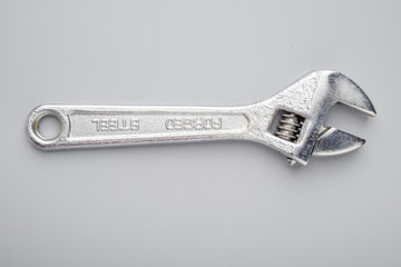 Adjustable spanner on grey background