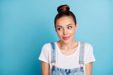 Portrait of sweet person looking wearing white t-shirt denim jeans overalls isolated over blue background