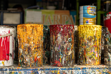 Used paint pots covered in paint drips and splatters in Jakarta Indonesia