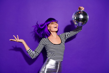 Portrait of lovely youth holding mirror ball close eyewear eyeglasses eyewear skirt isolated over...