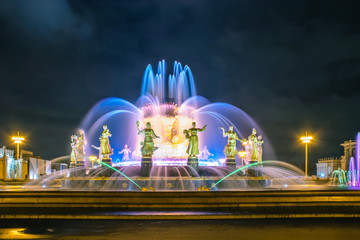 Multicolored fountain of the friendship of nations on VDNKH at night, Moscow, Russia