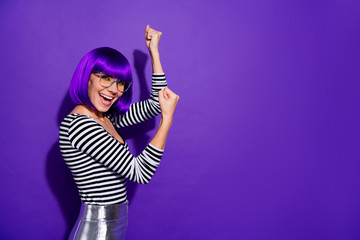 Portrait of lovely lady raising fists screaming shouting yeah isolated over purple violet background