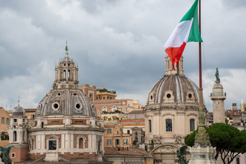 Fototapeta na wymiar Roman Churches with Italian flag in foreground