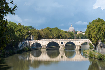 Fototapeta na wymiar River Tiber and sisto bridge with St Peters in the distance Rome