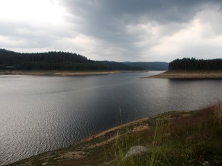 Mountain landscape with lake, trees and clouds