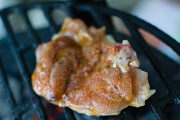 Closeup of chicken thigh on the grill