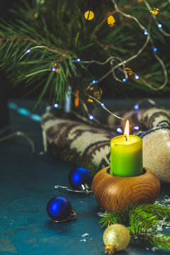 Christmas and New Year composition. Candles and holiday decor, branches of pine and spruce,  bokeh, dark background.