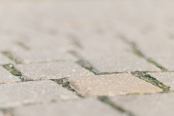 Abstract gray background of old street cobblestone street close up. Selective focus