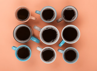 Coffee in the different cups on the beige background. Flatlay, cheerful day concept