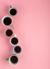 Coffee in the different cups on the pink background. Flatlay, cheerful day concept, vertical orientation