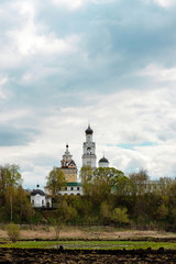 Landscape spring meadow view on church bell of Annunciation female monastery in Kirzhach, Vladimir region, Russia.