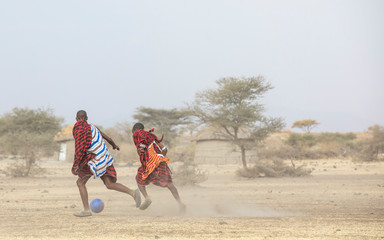 maasai men playing footballing soccer