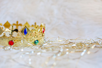 Golden crown of Christmas magician king with colored gems. Copyspace right.