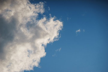 Fototapeta na wymiar Large white cumulus clouds against a blue sky.