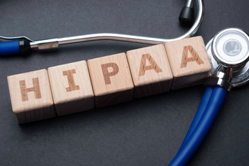 Wooden block form the word HIPAA (Health Insurance Portability and Accountability Act) with stethoscope. Medical concept.
