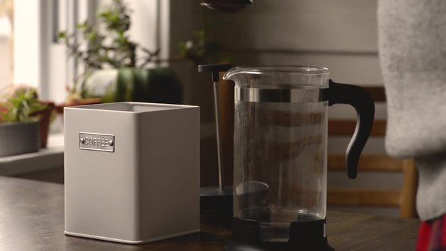 filling french press coffee maker in the kitchen