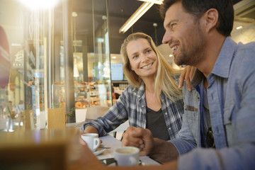 Middle-aged couple sitting at coffee shop
