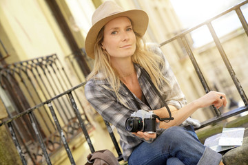Beautiful blond woman photographer in European city