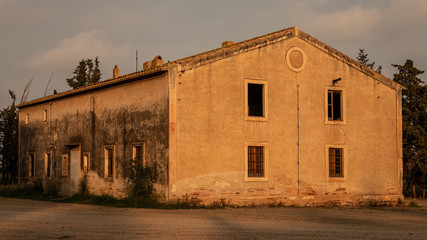 Fototapeta na wymiar Old building in the sun set