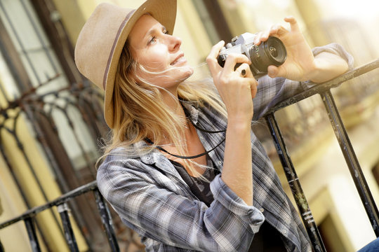 Beautiful blond woman photographer in European city