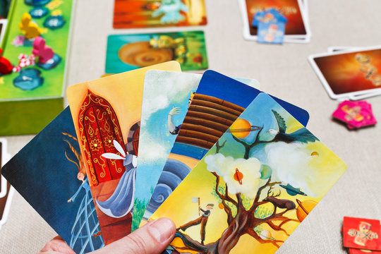 MOSCOW, RUSSIA - FEBRUARY 3, 2014: playing in Dixit card game. The game was created by Jean-Louis Roubira in 2008, and in 2010 the game received prestigious award Spiel des Jahres (Game of the Year)