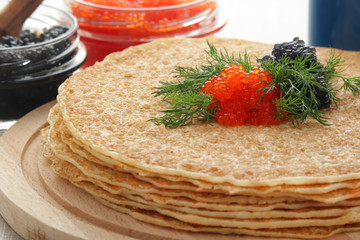 Russian pancakes with red and black caviar	